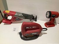 Photo of Skil reciprocating saw, jigsaw, and handheld work light showing overall condition and color scheme.