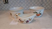 Overview of the three serving pieces: oven-safe dish, bowl, and gravy boat with blackberry design.