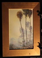 Photo of original framed palm tree painting showing three slender palm trees in muted colors with a gold frame.