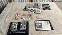 Full view of card collection and memorabilia on beige surface including cards spread in stacks and plaques near the front.