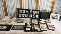 Full view of the collection showing multiple photo albums and loose photos spread on a surface