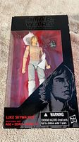 Front view of Luke Skywalker action figure in original packaging with visible box damage and missing accessories.