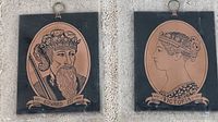 Two copper etched plaques depicting King Edward III and Queen Victoria, each mounted on black backing boards with hanging rings