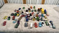Wide view showing entire collection of about 45 diecast cars and vehicles.