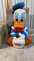 Front view of Walt Disney Donald Duck cookie jar showing character details and 'COOKIES' label on jar.