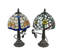 Front view showing both Tiffany style lamps side by side with stained glass shades and ornate metal bases.