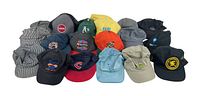 Wide view of all 19 hats in the lot showing various styles, colors, and logos.