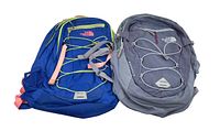 Both backpacks together showing blue and gray designs and front bungee cords