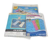 Three new inflatable water floats in original packaging: Sun Shine 72-inch float, Joe Boxer Air Mat, and Poolmaster polka dot mattress float.