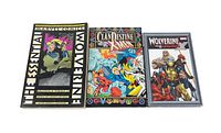 Three X-Men / Wolverine trade paperback comics laid side by side showing front covers.