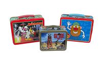 Three metal lunch boxes arranged with front artwork visible: Woody Woodpecker, Mr. Potato Head, and GI Joe with GI Joe thermos.