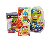 Front view of four Mr. and Mrs. Potato Head toys including boxed versions and a plastic carry case.