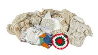 View of whole lot of crochet doilies and embroidered napkins, showing color, texture and variety.