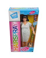 Front view of Edna Turnblad doll in original colorful Hairspray box showing the doll and some accessories inside.