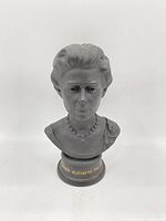 Full front view of the black basalt bust showing the Queen's upper body and inscription on base.