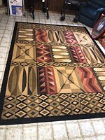 Full view of the acrylic rug showing the entire geometric pattern and color scheme.