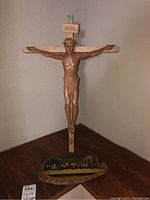 Full view of the resin crucifix mounted on wooden cross with Last Supper wood plaque beneath.