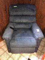 Front view of dark blue textured fabric La-Z-Boy recliner with remote control on right armrest, showing wear and usage marks.