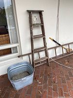 View of two wood ladders and metal basin showing their condition and style.