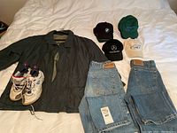 Full display of jacket, sneakers, jeans, and hats showing brands and conditions