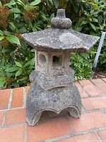 Front view of the assembled stone pagoda lantern showing weathered surface and shape
