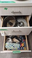 Top drawer with bundt and tube pans, muffin tin