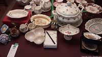 Overview of lot items on table including tureen, plates, candy dishes, mugs, and bowls