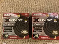 Two boxed Big Boss XHose Pro 50 ft expandable hoses showing front packaging with product details.