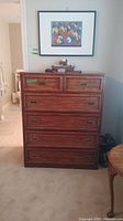 Front view of the Koehler wood dresser with five drawers, showing dark wood finish and metal recessed handles.