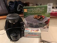 Bosch coffee machine, Hot Stone Grill box, and grater on a counter.