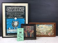 Three framed rock memorabilia prints displayed together on table and against black backdrop