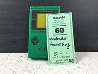 Front view of green Nintendo Game Boy with tag showing 'Nintendo Game Boy'