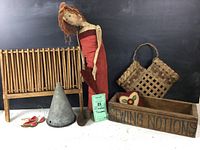 Photo showing all items in the lot including the tall red-dressed fabric doll, wooden dish rack, wooden box with SEWING NOTIONS label, woven heart basket, metal cone, copper scoop, and metal chili pepper ornaments.