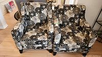 Two matching floral-pattern upholstered chairs side by side.