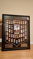 Front view of large framed display featuring NFL Super Bowl tickets and a central Super Bowl XLII artwork.