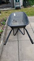 Front view of the wheelbarrow showing the tub, handles, and grips.
