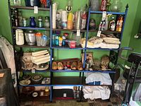 Full view of shelving unit loaded with items to show structure and size.