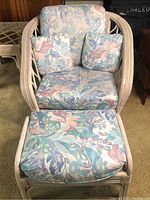 Front view of the Bench Craft cane chair and matching cushioned ottoman showing floral upholstery and cane frame.