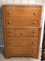 Front view of the complete maple dresser showing all drawers and overall wear.