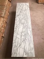 Full top view of the rectangular marble coffee table showing natural grey veining on white marble.