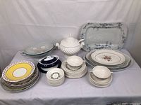 Full lot arrangement showing all plates, platters, covered tureen soup dish, and various bowls.