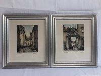 Two framed European street and architectural scene prints signed by the artists