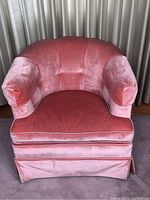 Front-facing photo of the vintage pink velvet tub chair, showing overall condition, color, and structure.