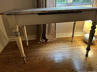 Front view showing full table design with turned legs and painted apron
