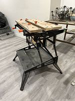 Side angle view of the Black & Decker Workmate 400 workbench showing the wooden work surfaces and black metal frame.