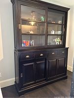 Front view of cabinet with upper glass doors, drawers and lower cabinets