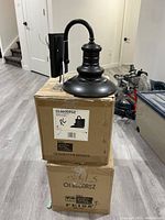 Two Generation Brands OL8600RSZ fixture boxes stacked with one fixture displayed on top