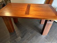 Angled view of extended table with four block legs