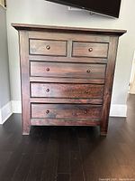 Front view of the dresser showing all five drawers and top surface.