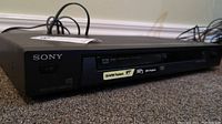 Front side view of Sony DVP-NS315 showing branding, playback and format labels (CD-R/RW and MP3) and disc tray.